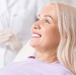 patient smiling while sitting in treatment chair   