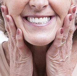 Closeup of smiling older woman with dental implants