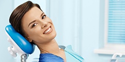 Young woman smiling while visiting oral surgeon