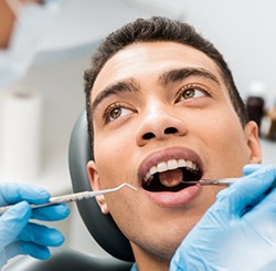 a patient undergoing a dental checkup for oral pathology