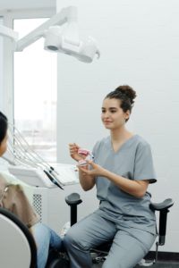 Dentist explaining benefits of a dental implant in Marietta, OH